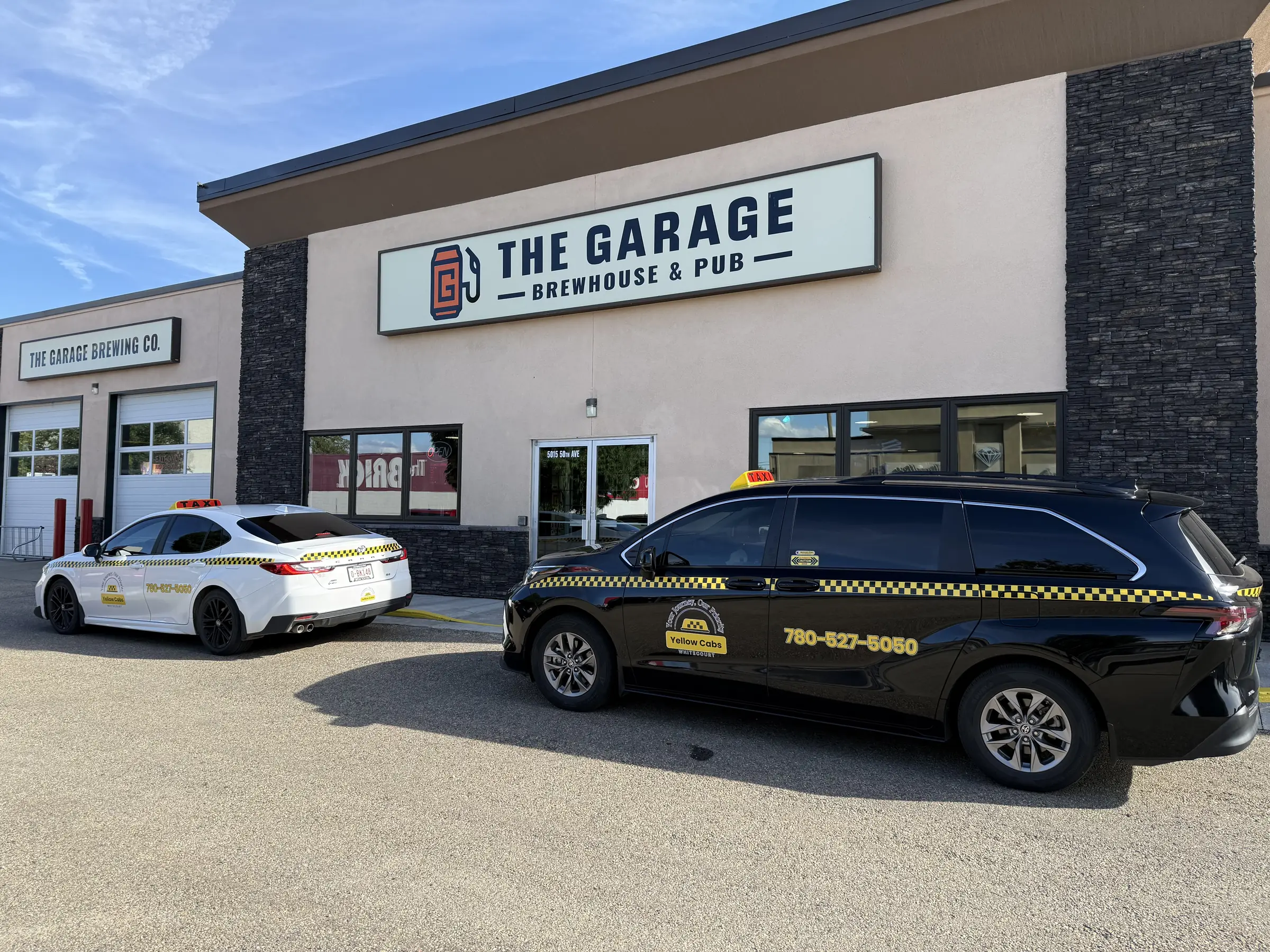 Yellow Cabs Whitecourt taxis outside a local Whitecourt business